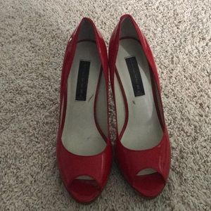 Patent red leather peep toe heels.